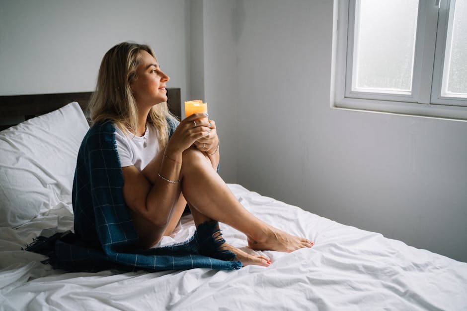 Person sitting in gentle morning light practicing grounded manifestation through meditation