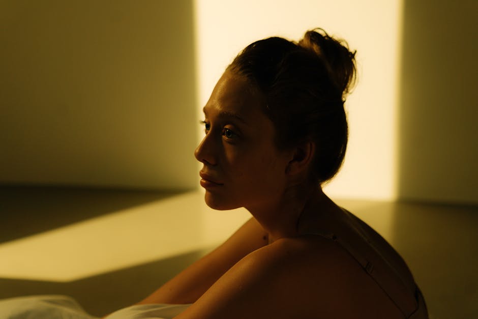 Sensitive woman meditating in morning light with eyes closed to soothe her nervous system