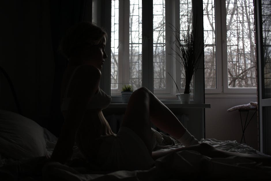 Sensitive empath woman sitting in morning meditation by a window supporting her nervous system