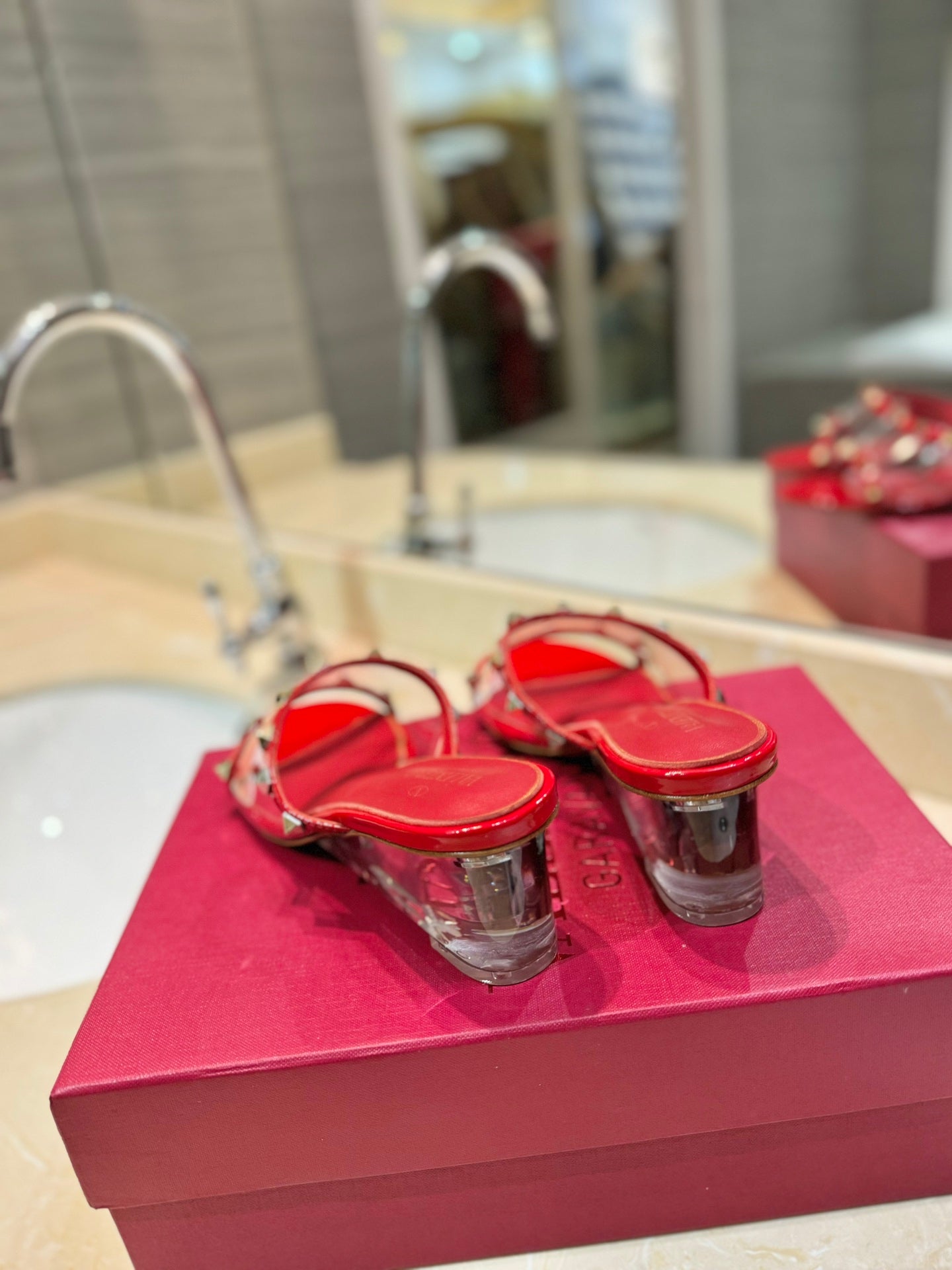 ROCKSTUD MULE SANDALS IN CHERRY RED CALFSKIN AND TRANSPARENT PVC FILM